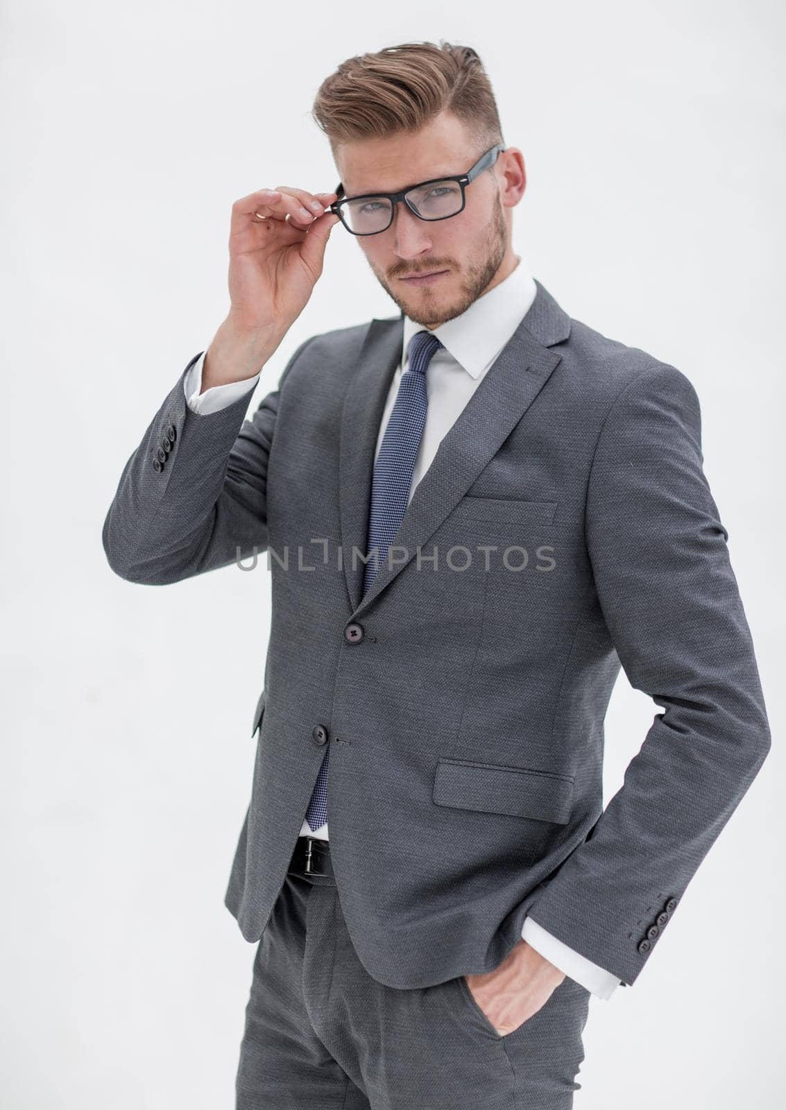 attentive businessman adjusting his glasses.isolated on white background