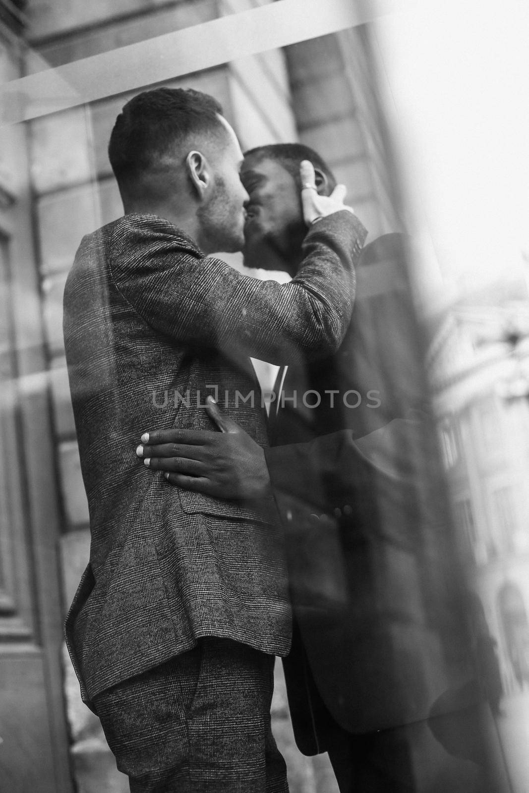 Black and white bw portrait Reflection in glass of two kissing men, afro american and caucasian in Paris by sisterspro