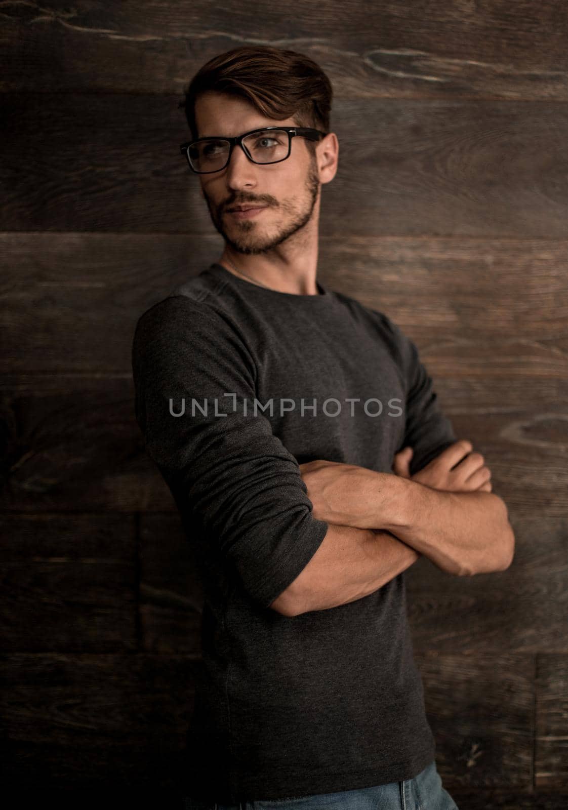 Elegant man in glasses over dark background. Optics style for men. Handsome businessman in spectacles. Male beauty, fashion.
