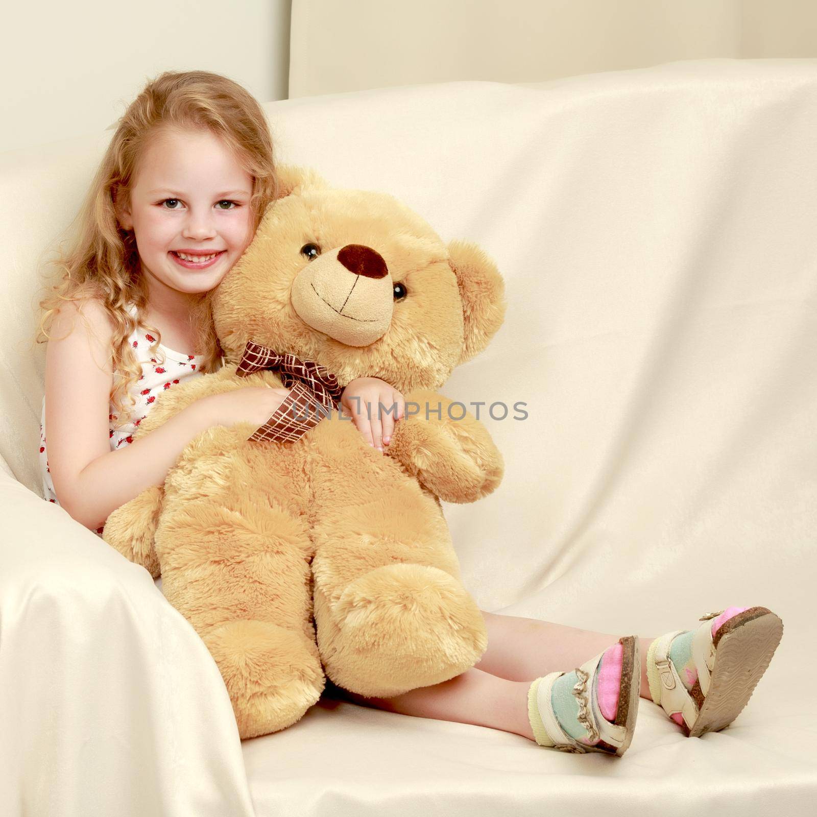 Little girl with a teddy bear. The concept of the game, raising a child in kindergarten and in the family.