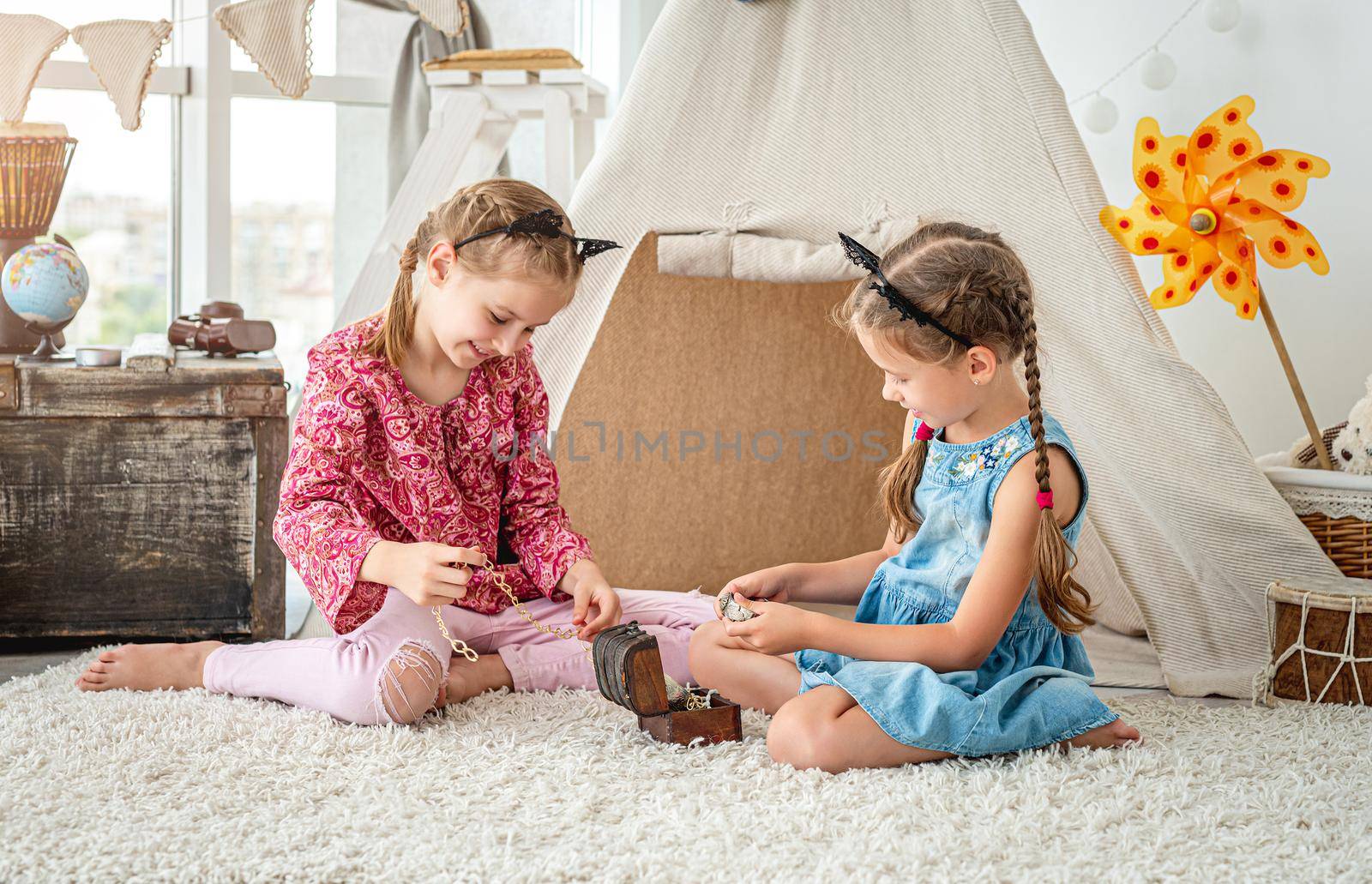 Little girls playing with treasure box by tan4ikk1