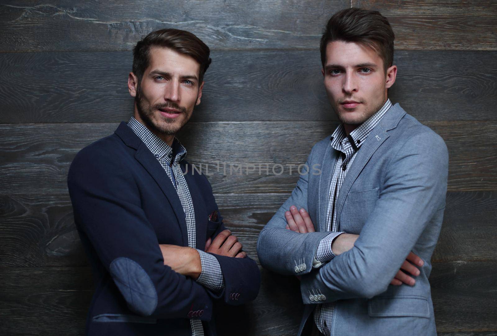 Portrait of two handsome businessmen CEO and executive confident grin