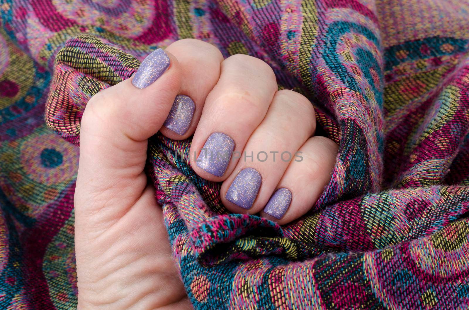 Hand of an adult woman with painted nails, manicure, nail polish. Studio Photo