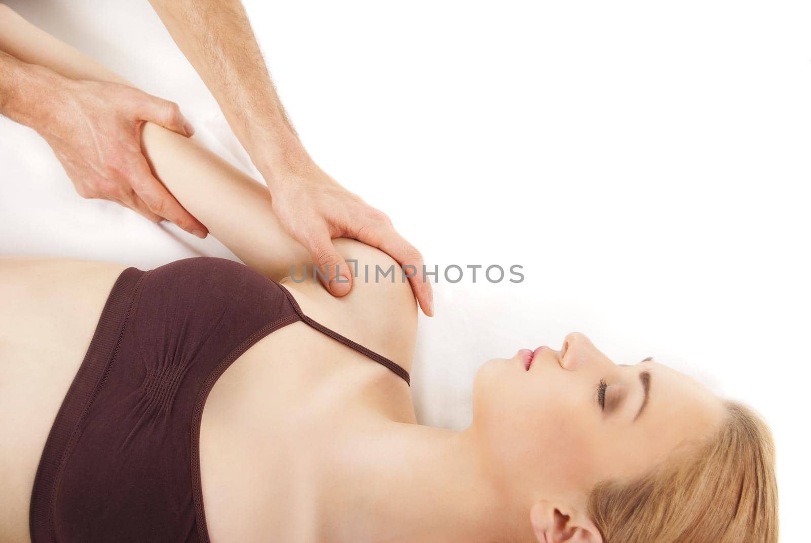 girl getting a massage - hands massaging her back - A pretty woman getting a shoulder and back massage