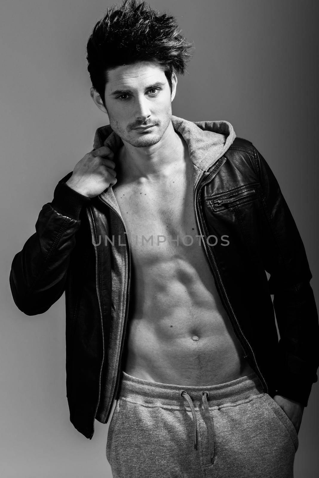 Athletic man wearing hoodie jacket. Studio shot by javiindy