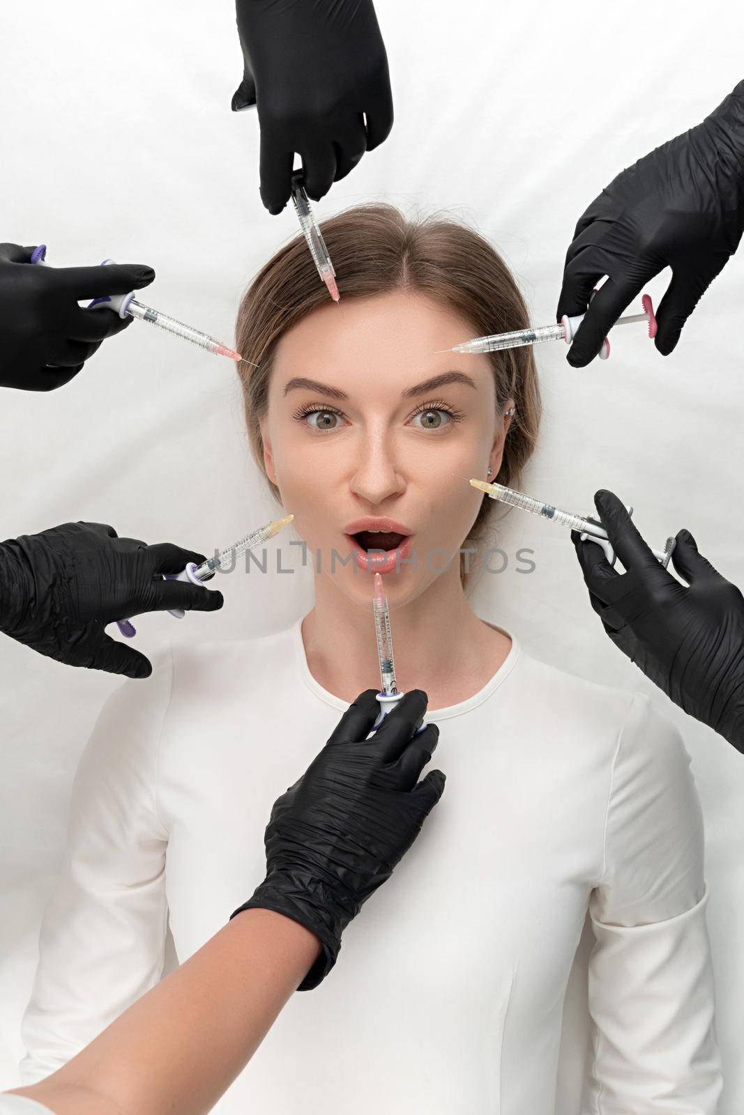 Conceptual beauty and cosmetology image of the hands of several beauticians holding their respective equipment. Beauty concept. Cosmetology concept. Cosmetology salon. Cosmetic procedures mesotherapy
