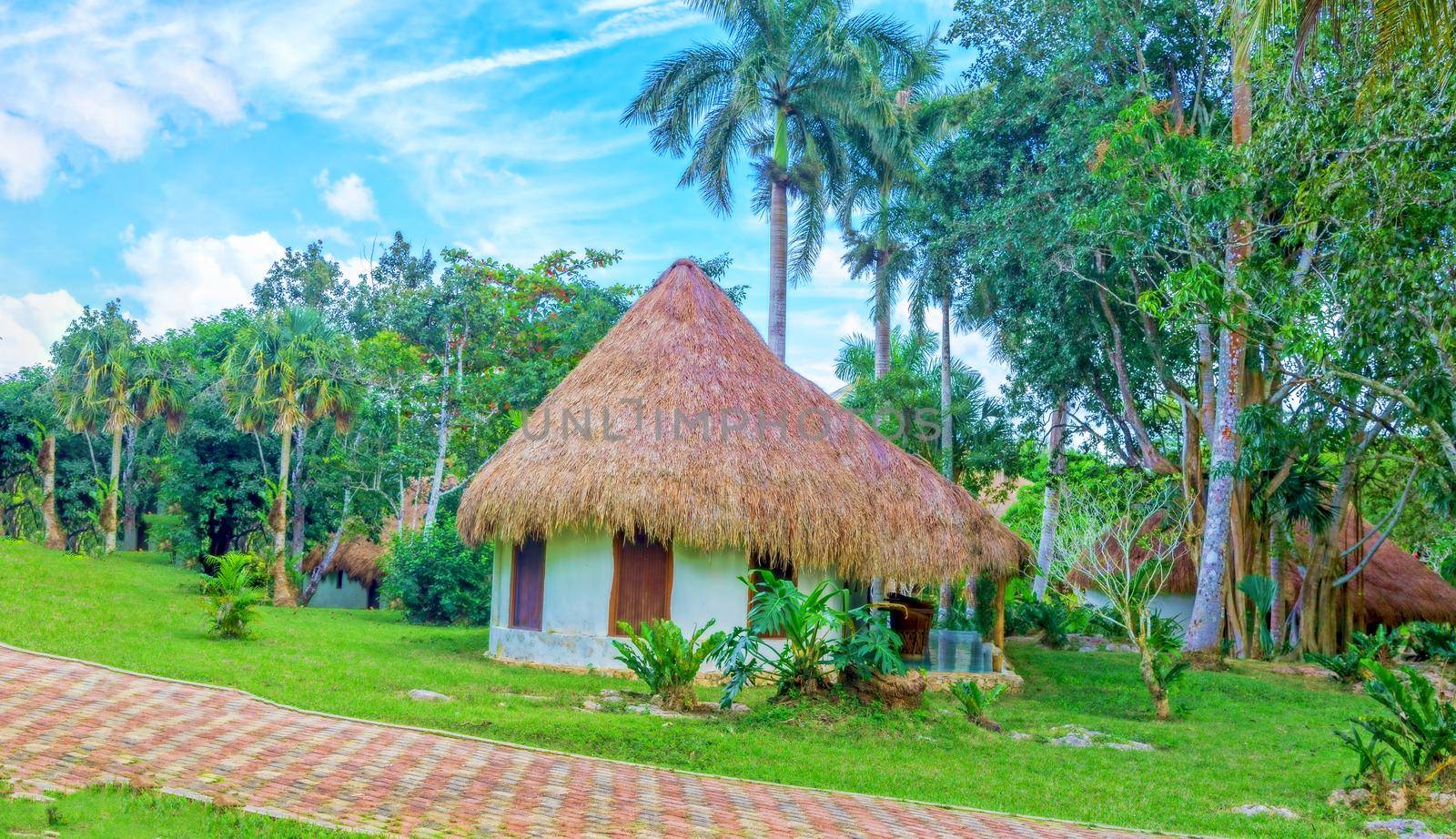 Romantic gazebo in the park with thatched roof. The concept of a family holiday, tourism.