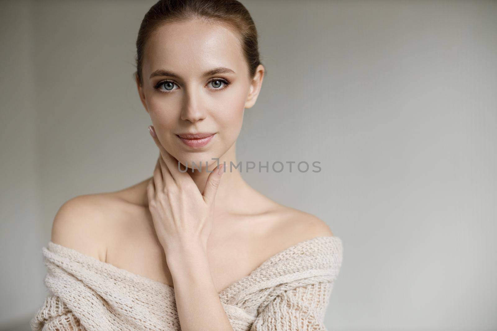 Portrait of a young pretty woman indoor in studio, skin wellness by splash