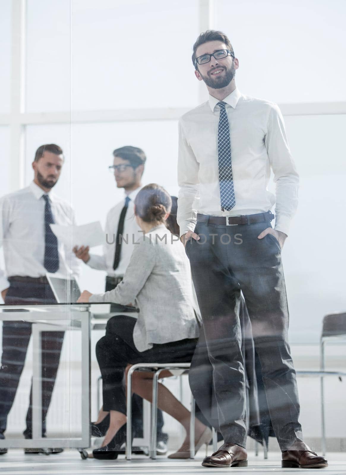 in full growth.confident businessman standing in the office.photo with copy space