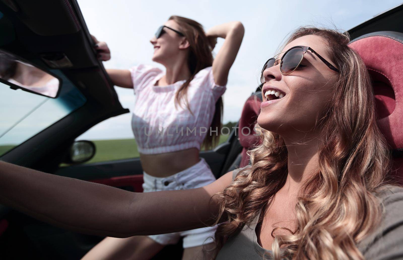 close up.happy young women driving a convertible car.summer holidays, travel, vacation, travel