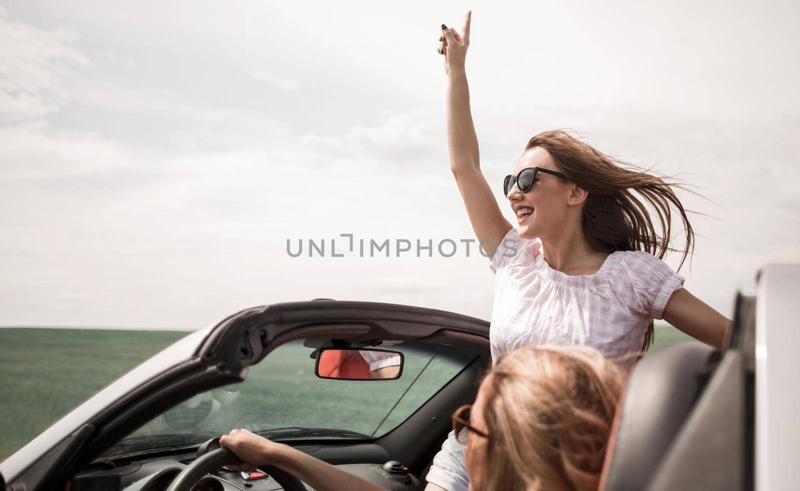 close up. happy young woman traveling in a convertible by asdf