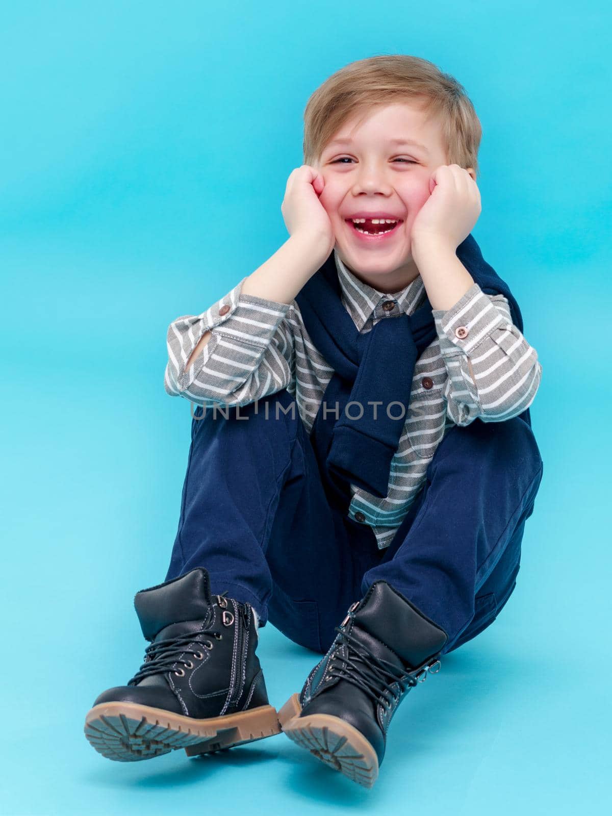 A beautiful little boy laughs fun. The concept of a happy childhood, well-being and family values.