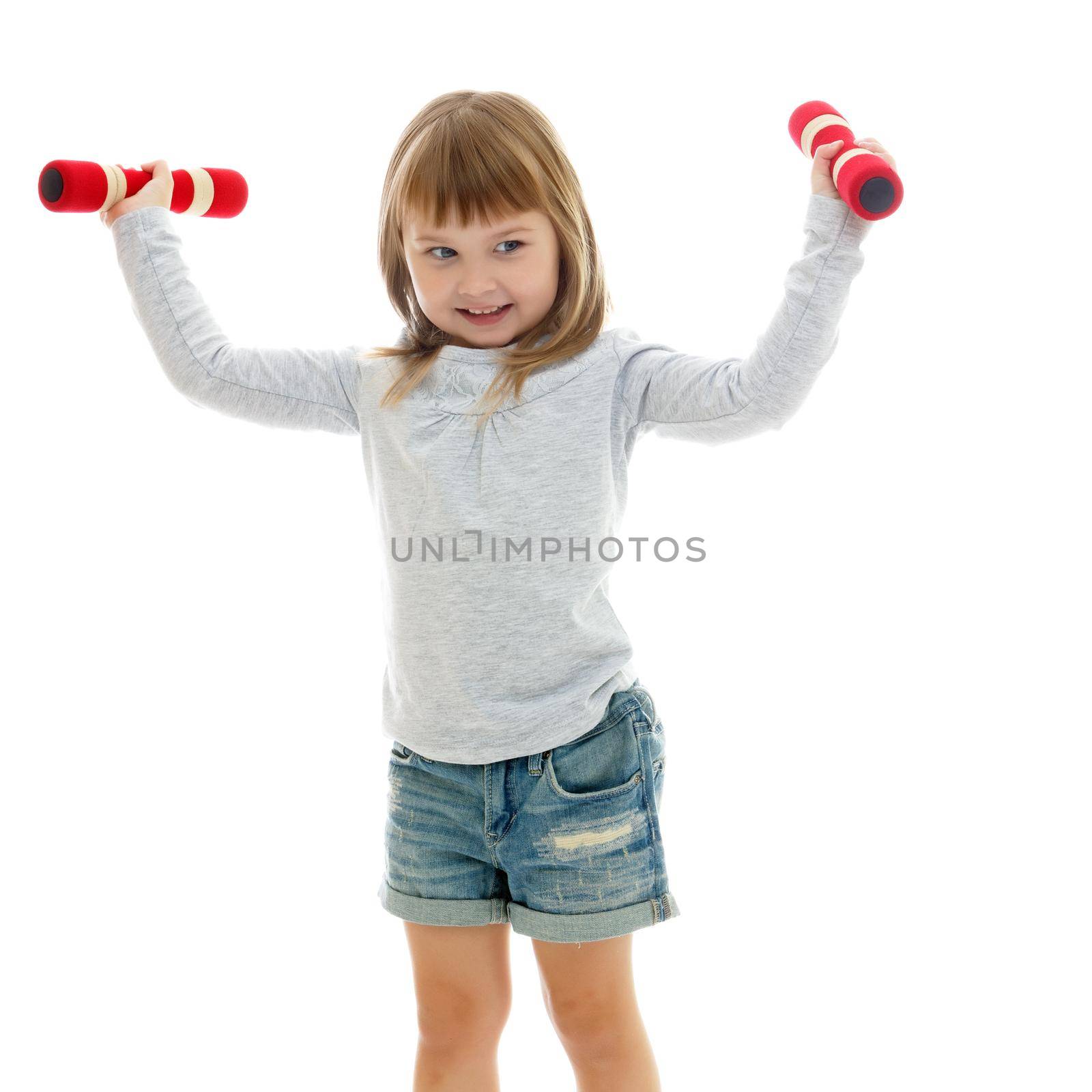 A cute little girl doing exercises with dumbbells. The concept of strength, health and sport. Isolated on white background.