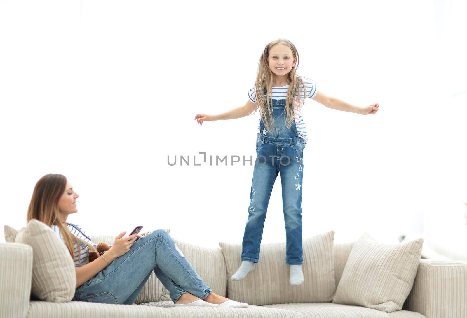 little girl jumping on the couch on the couch in the living room by asdf