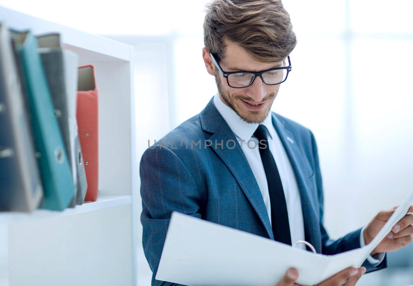 Successful businessman in elegant suit while working in office