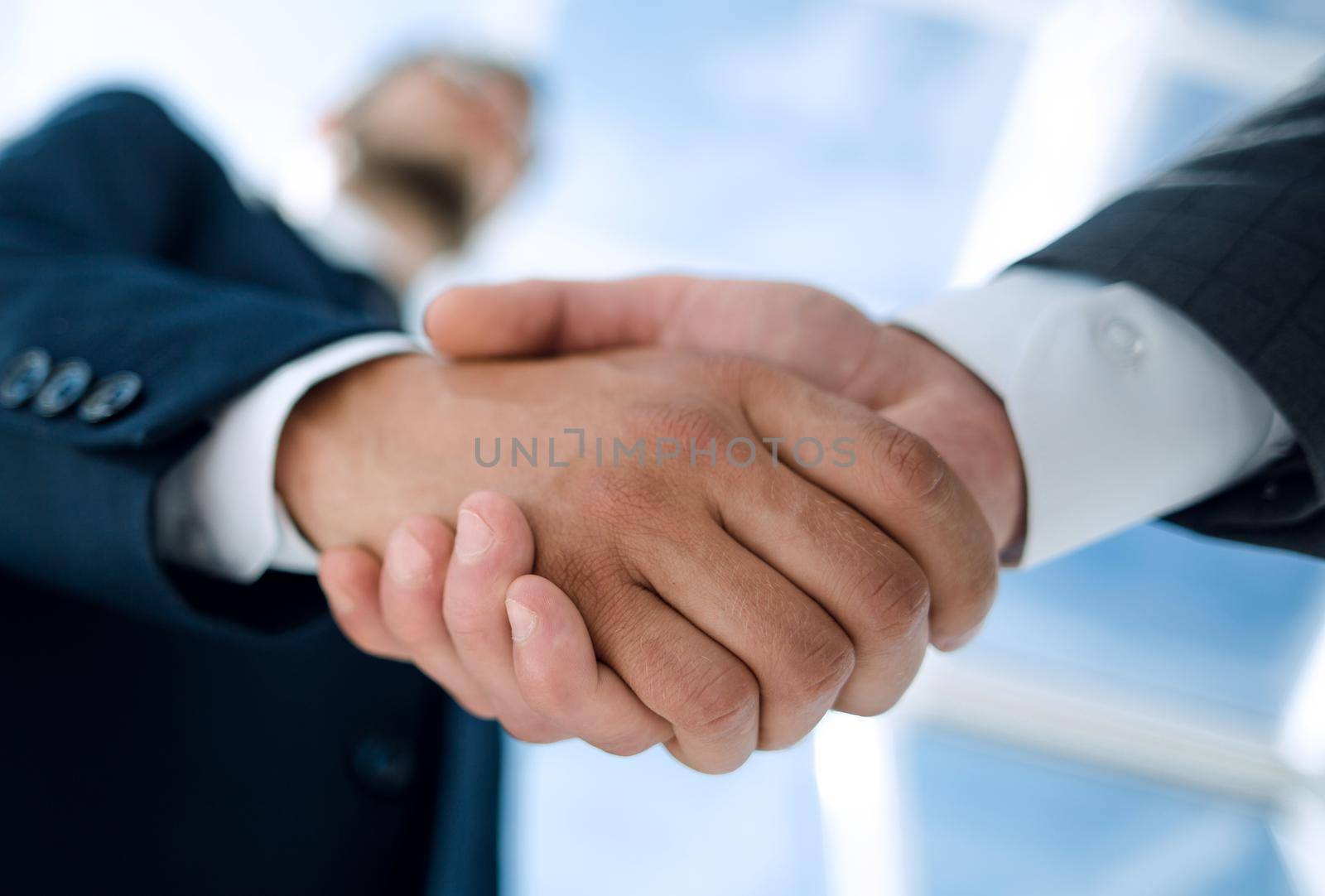 bottom view .handshake businessmen with a business partner