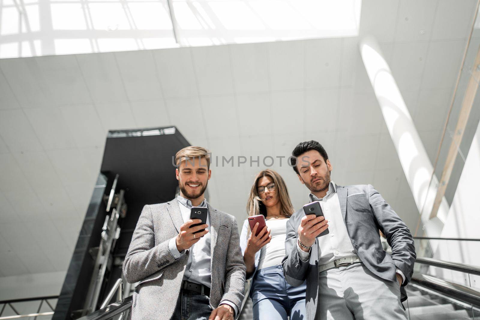 employees of the company standing on the escalator by asdf