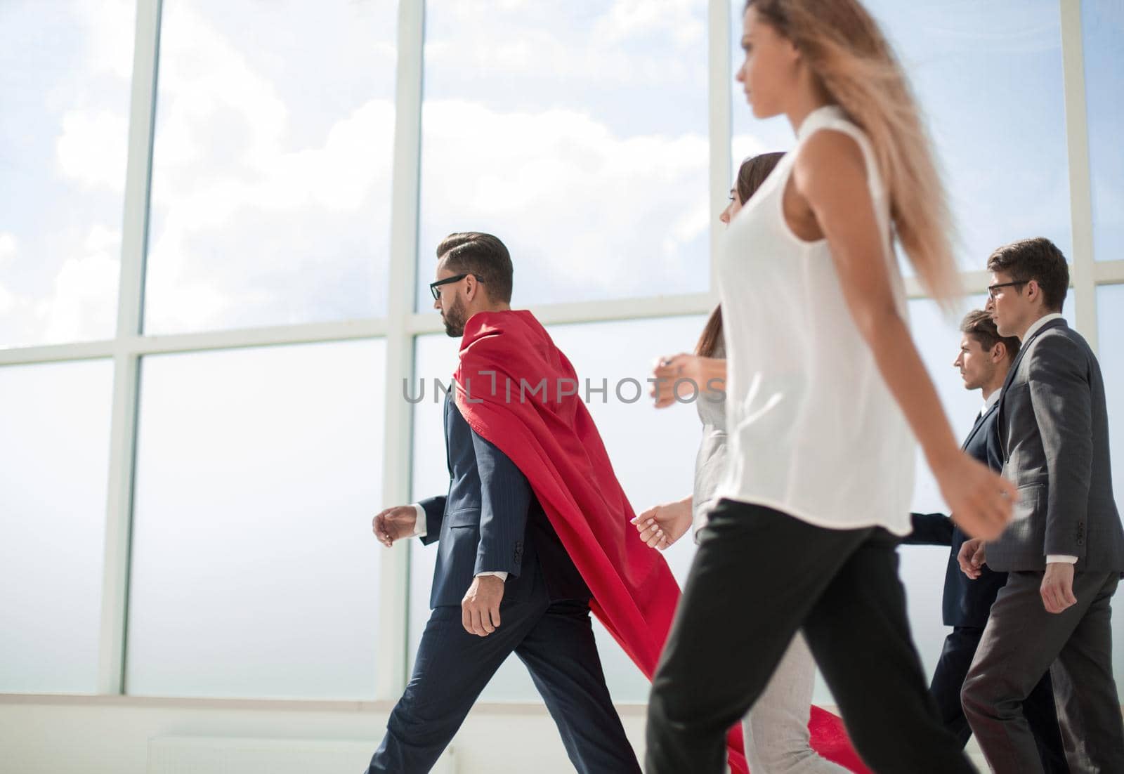 businessman superhero and his business team walking in office.photo with copy space