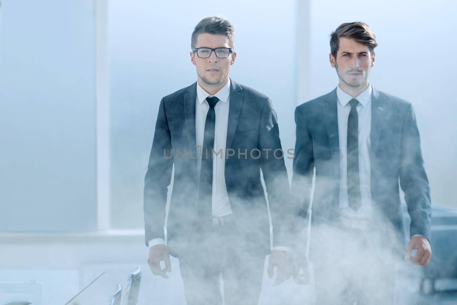 Young businessmen are evacuated from the office during a fire
