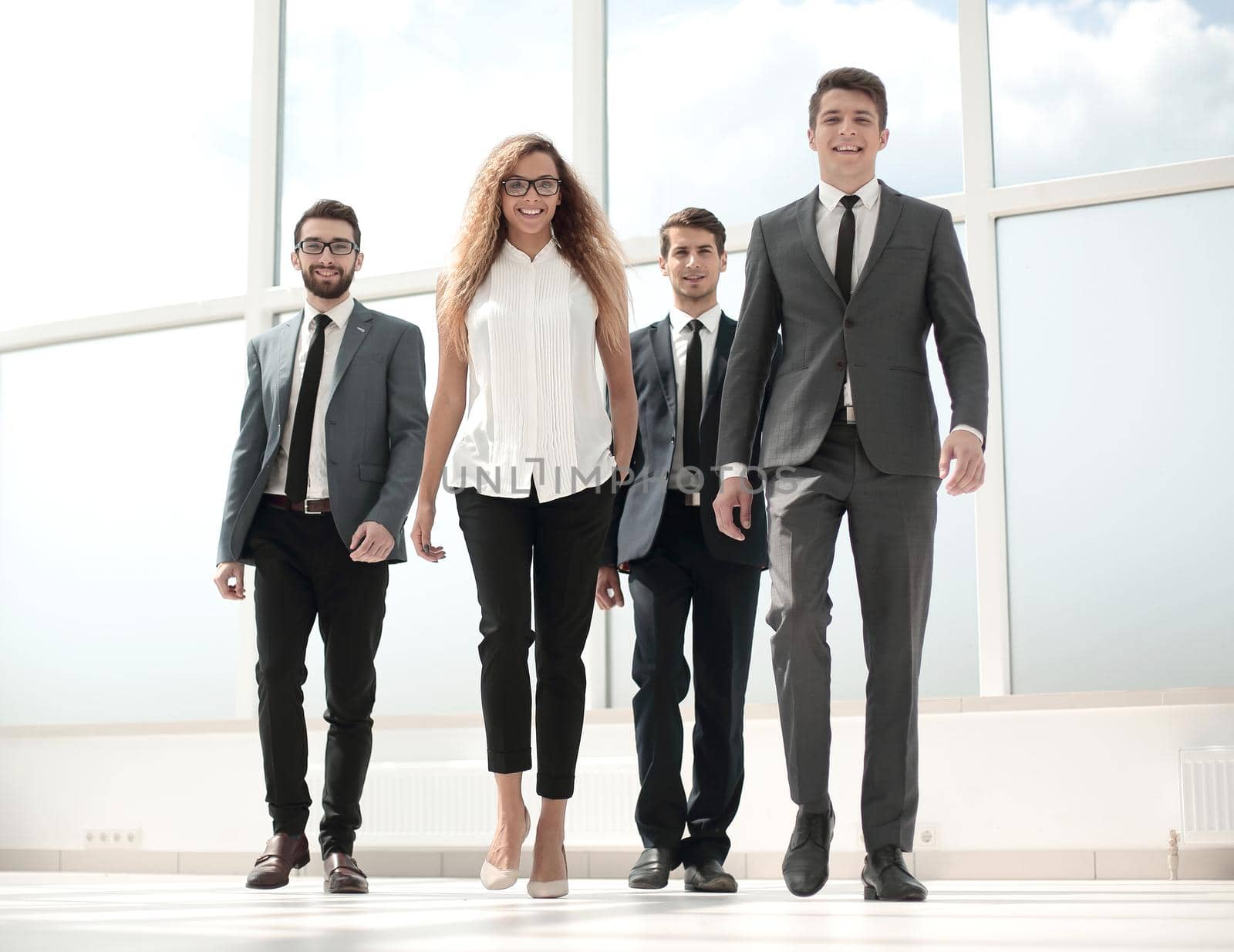 in full growth.a group of business people passing through the hall of the office.photo with copy space
