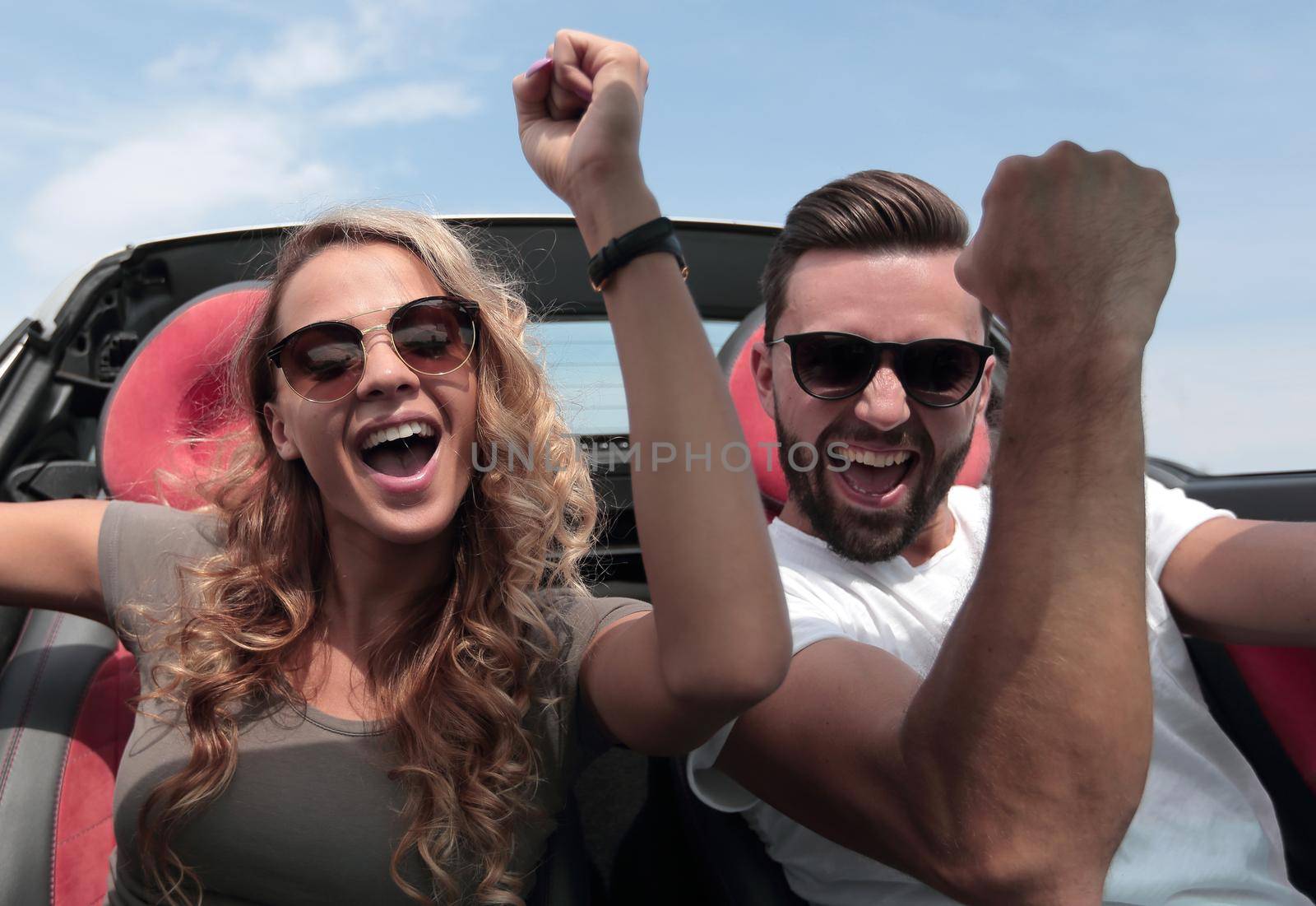 close up.a happy couple travelling in a convertible.the freedom of the open road