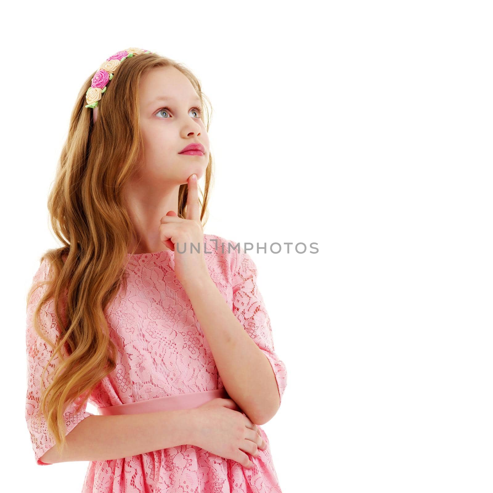 A cute little girl is looking up. The concept of emotions, happy childhood. Isolated on white background.