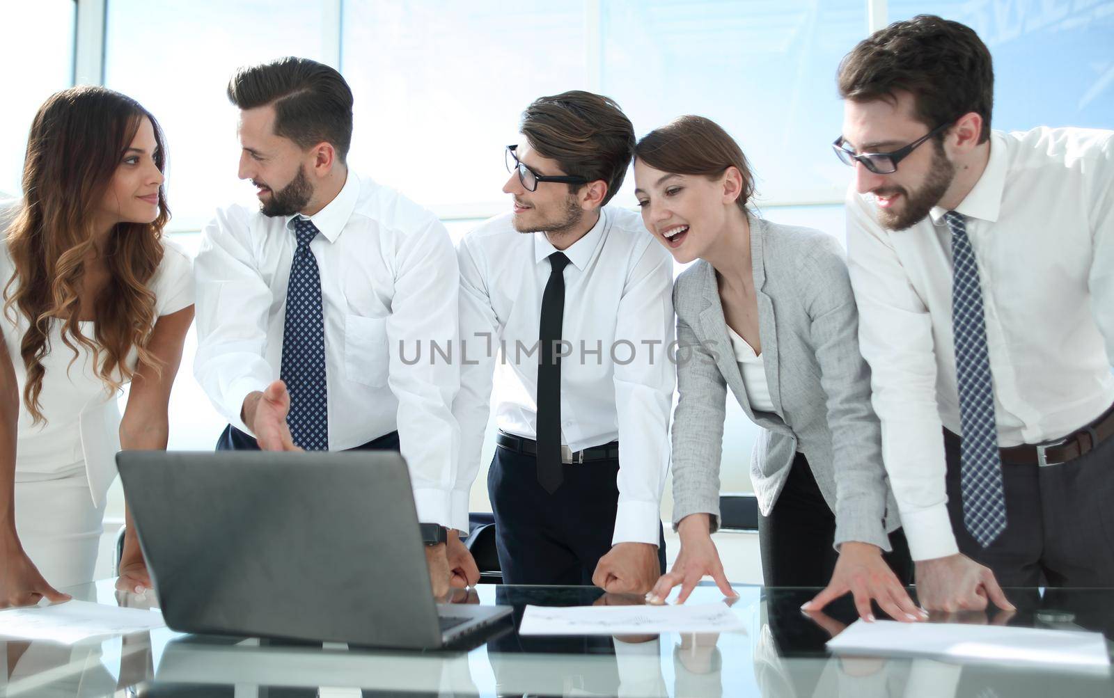 employees look closely at the laptop screen by asdf