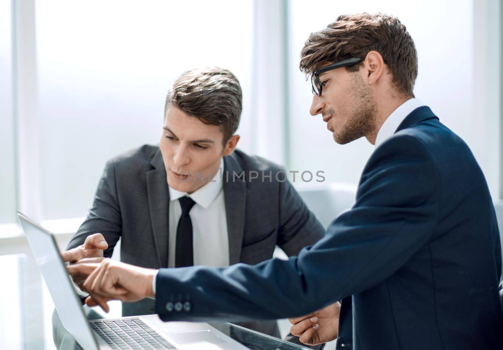 two businessmen use a laptop in the office.people and technology