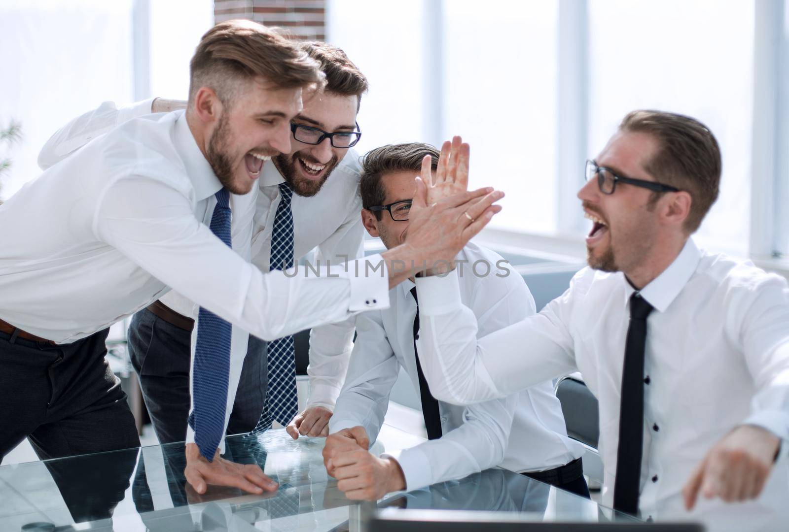 employees giving each other a high five.success concept