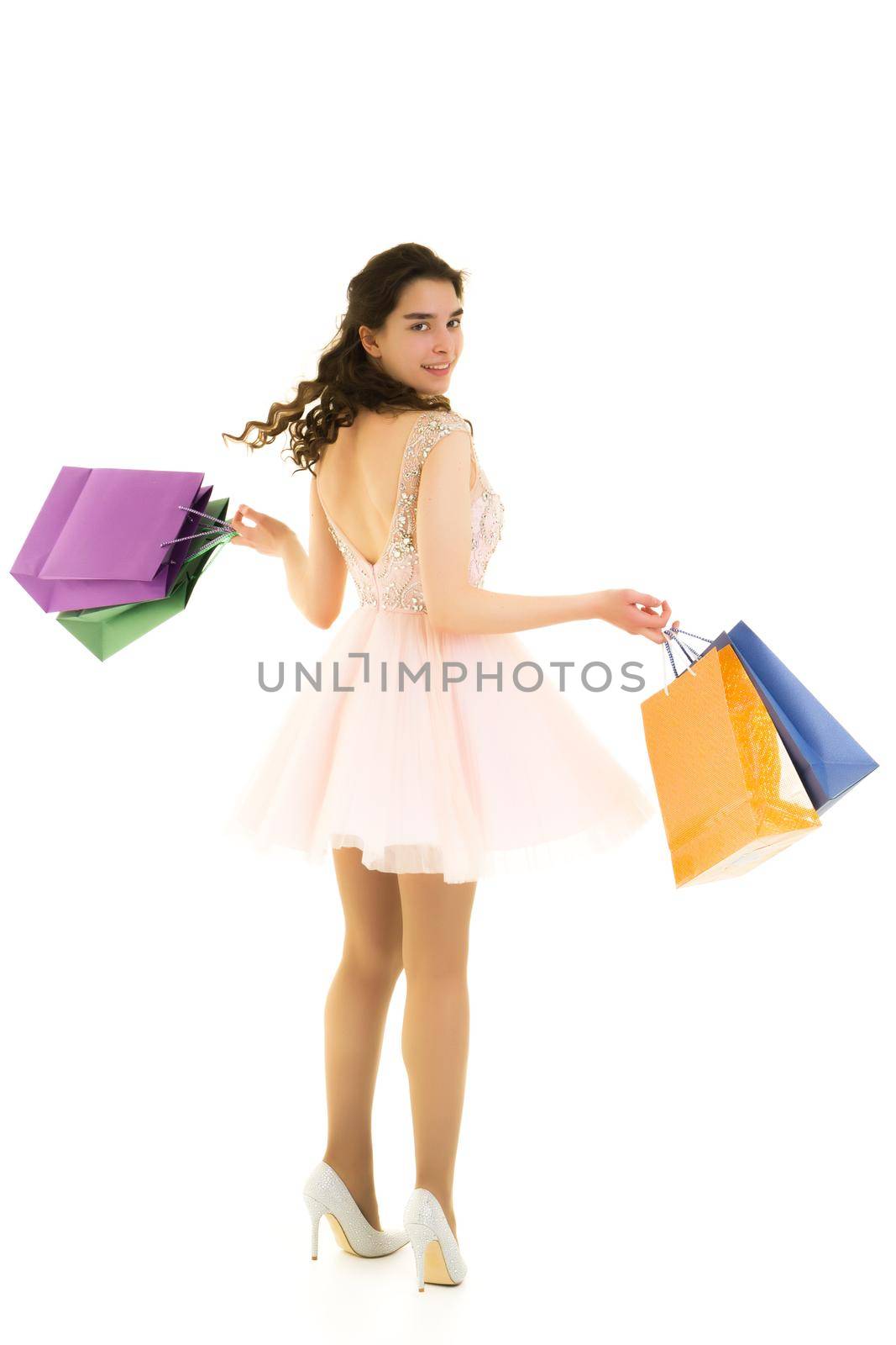 Teenager girl shopping in a store with large paper bags. by kolesnikov_studio