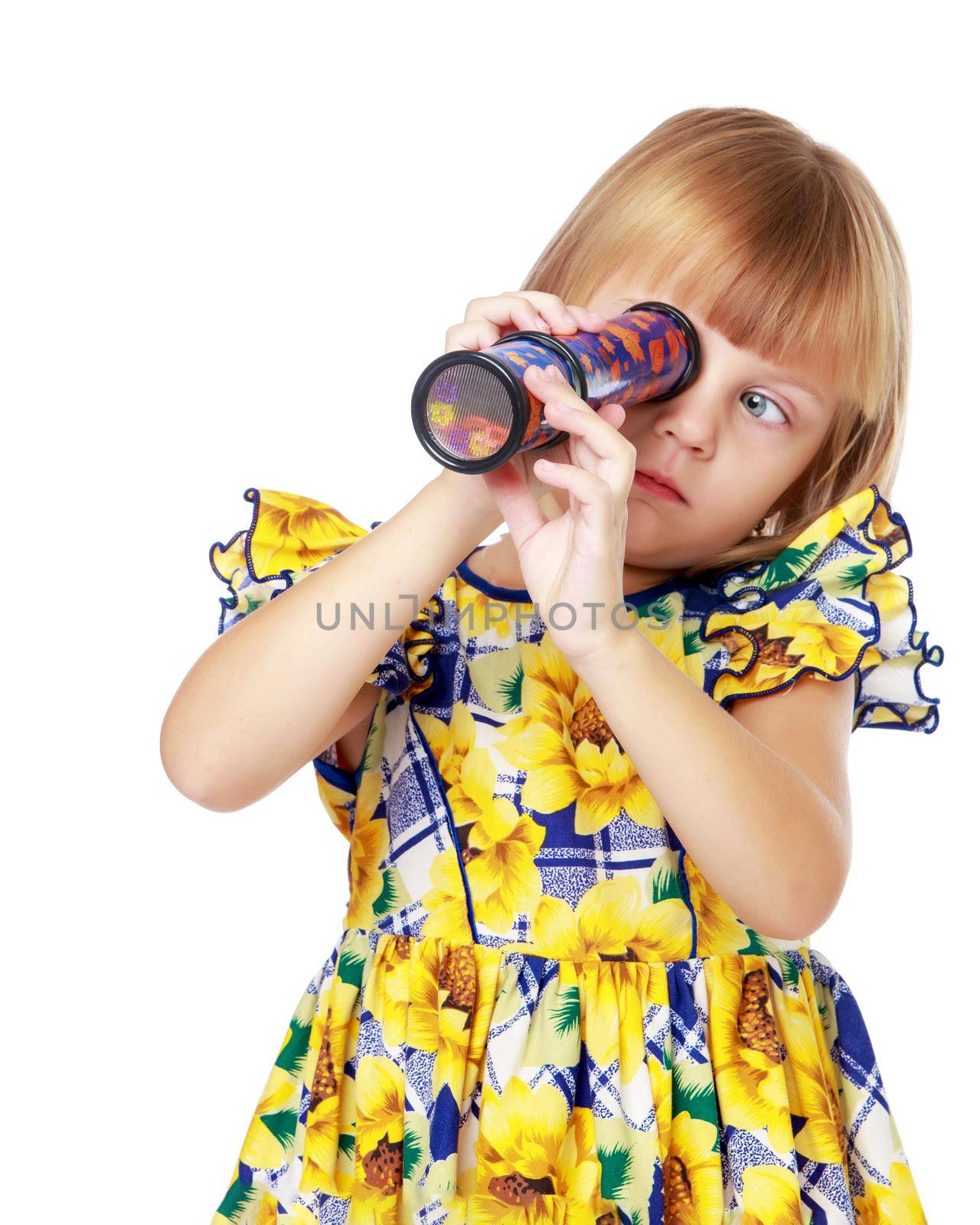 A cute little girl looks enthusiastically through a telescope, or into a kaleidoscope. Education concept.Isolated on white background.