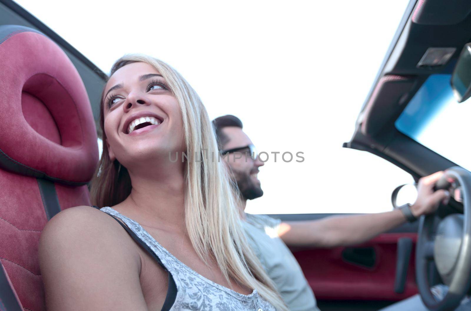 Travel with comfort.young young young woman and her boyfriend sitting in convertible