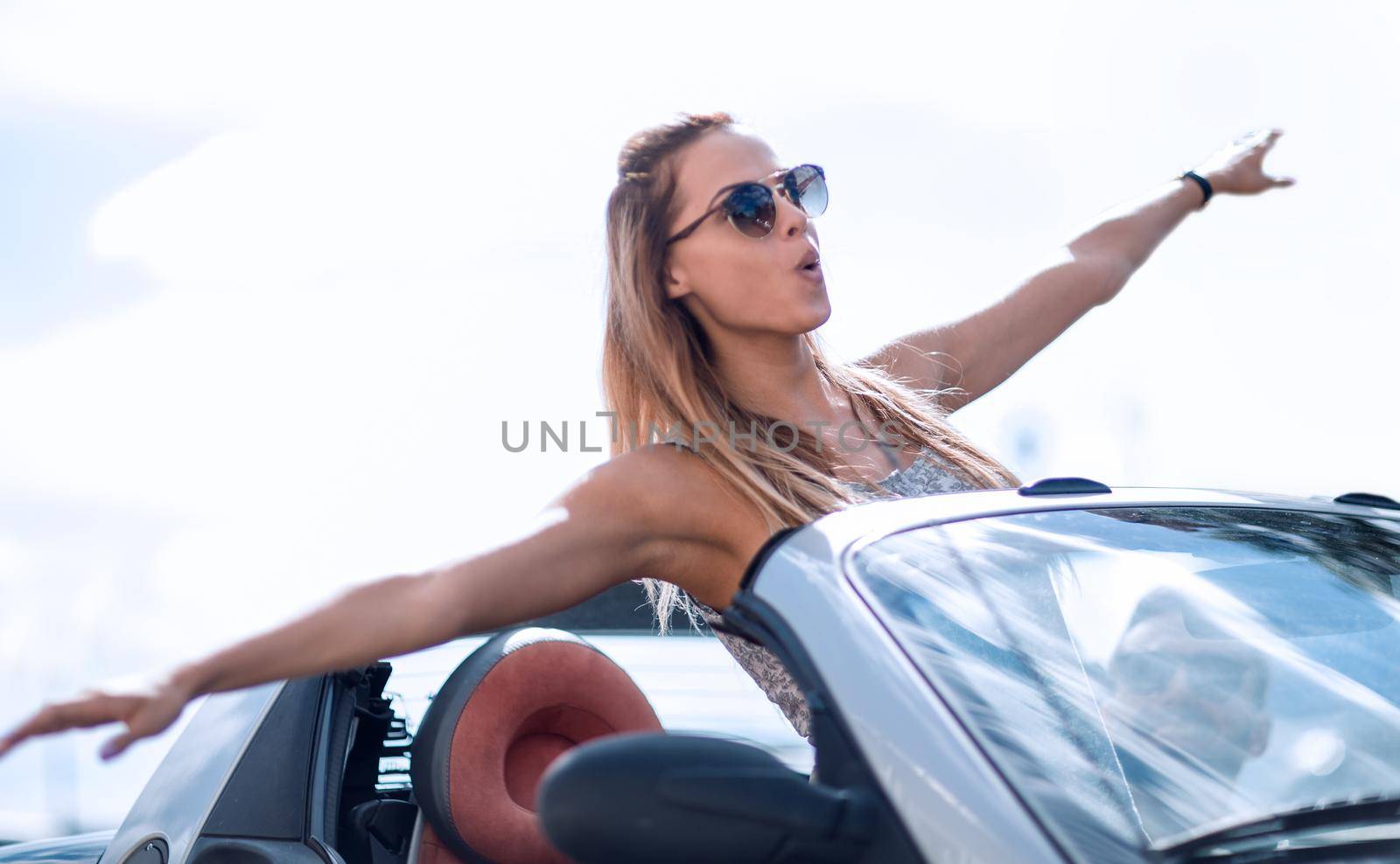modern girl enjoying a trip in a convertible by asdf