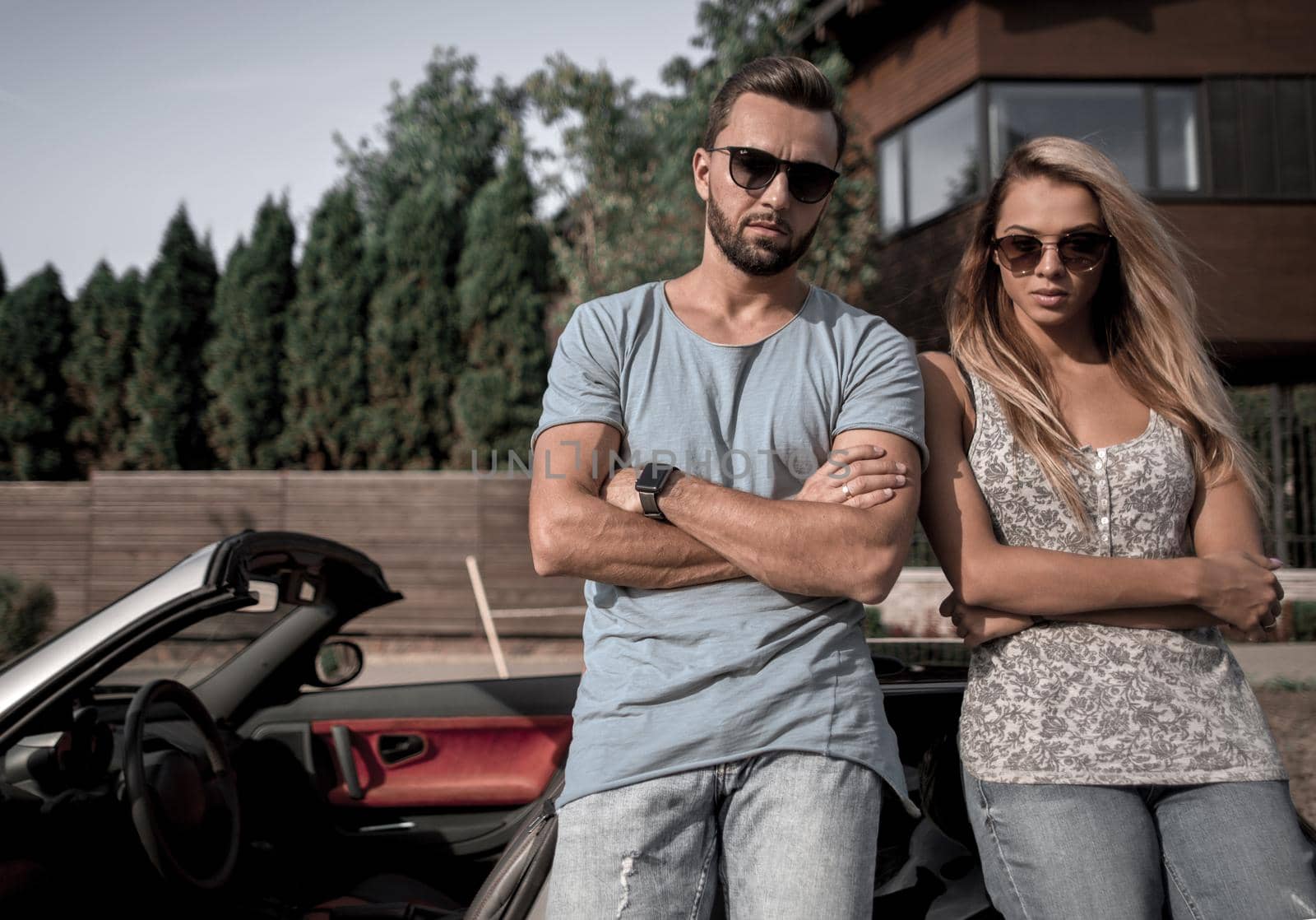 young couple standing near luxury car. by asdf