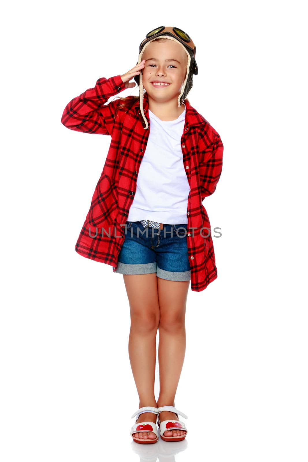 Little girl in helmet pilot with wooden plane in hand. The concept of family happiness, the embodiment of a dream, a love of travel. Isolated on white background.