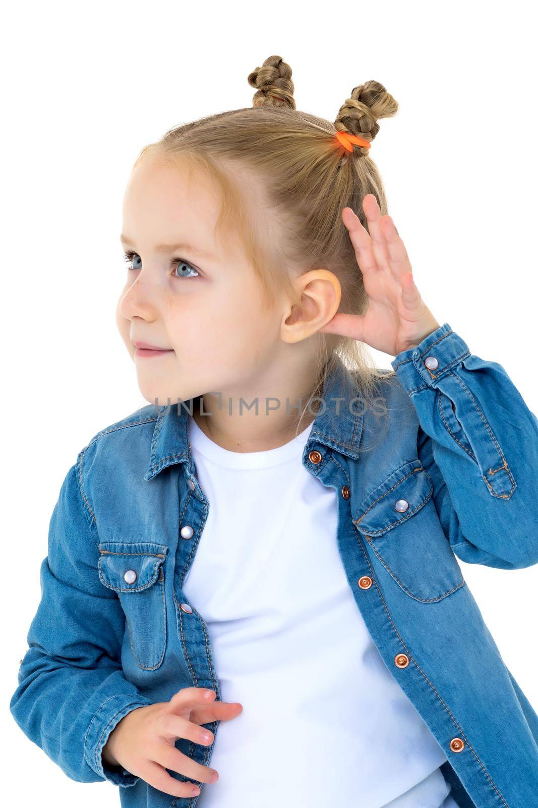 The little girl is listening. The concept of curiosity and secrets. Isolated over white background