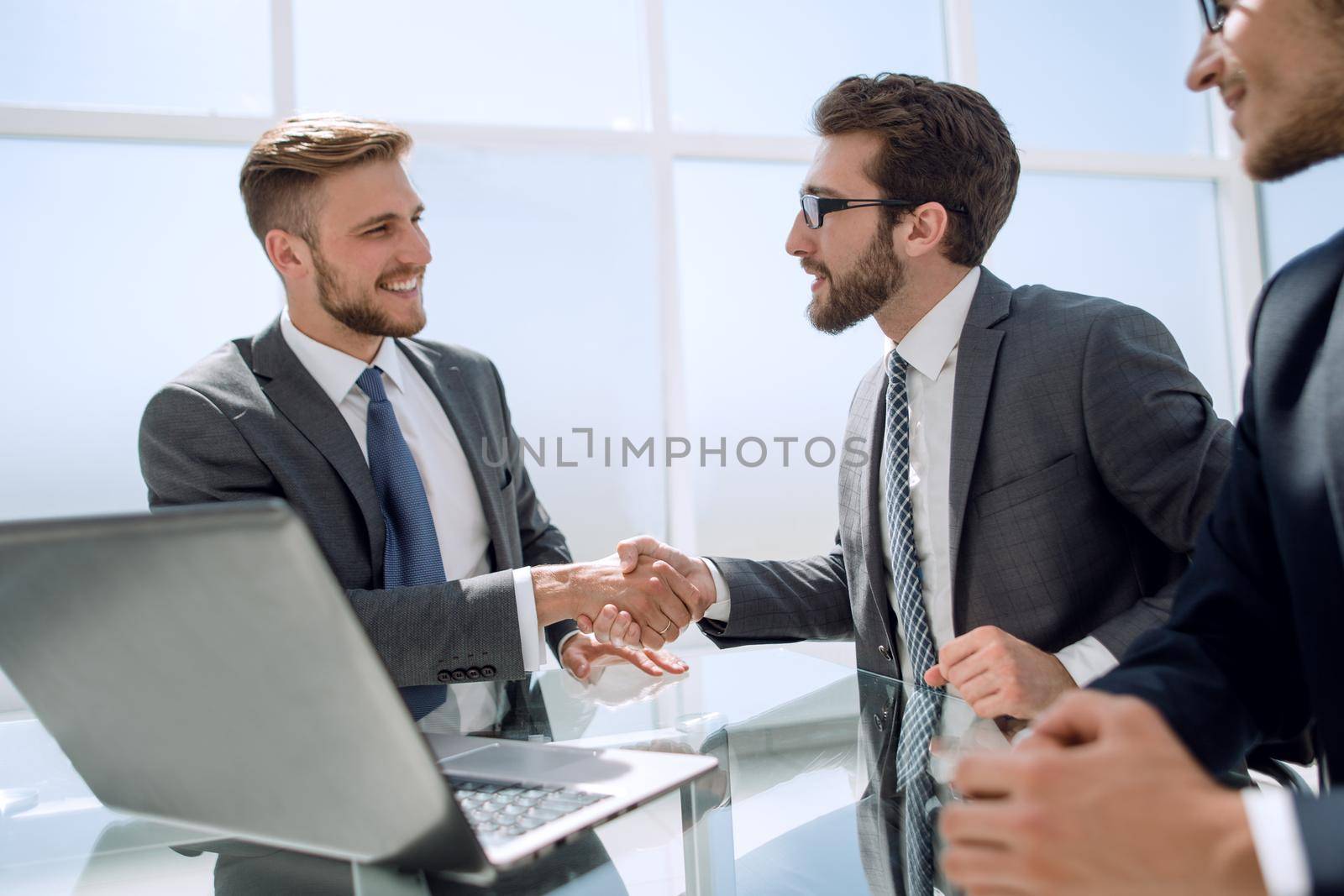 handshake employees at the Desk.the concept of cooperation