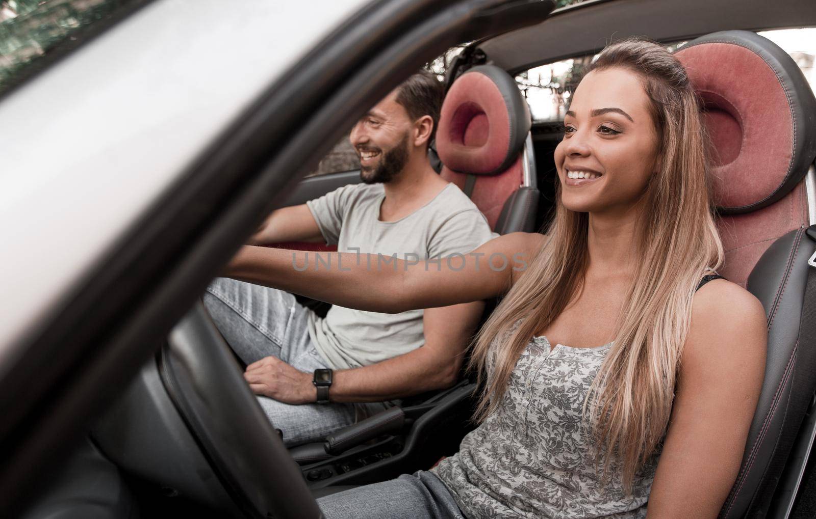 young woman behind the wheel of the family car. the concept of a successful life style
