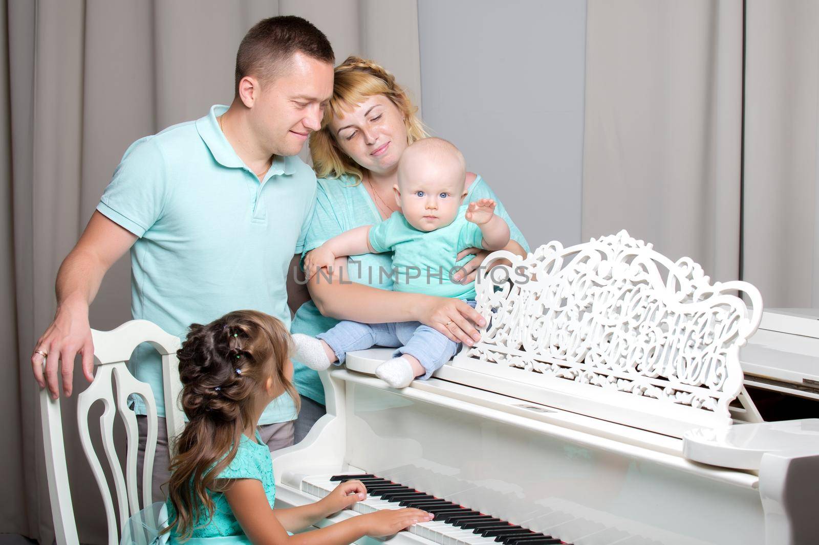 Happy family with young children. The concept of family happiness and development of children. Isolated on white background.