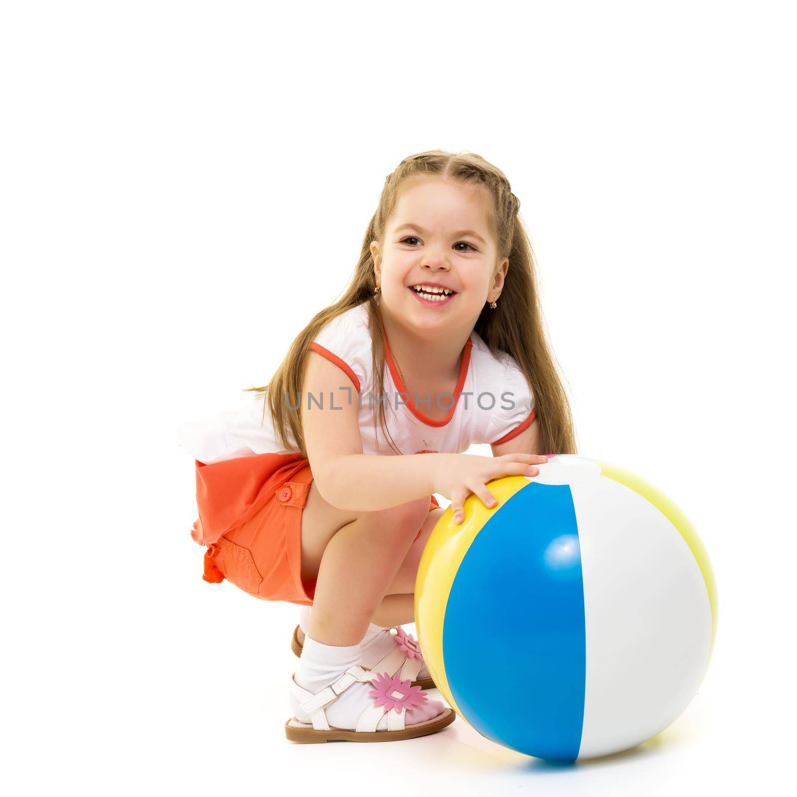A good girl is playing with a big inflatable ball. The concept of a happy childhood, recreation in nature, exercise. Isolated on white background.