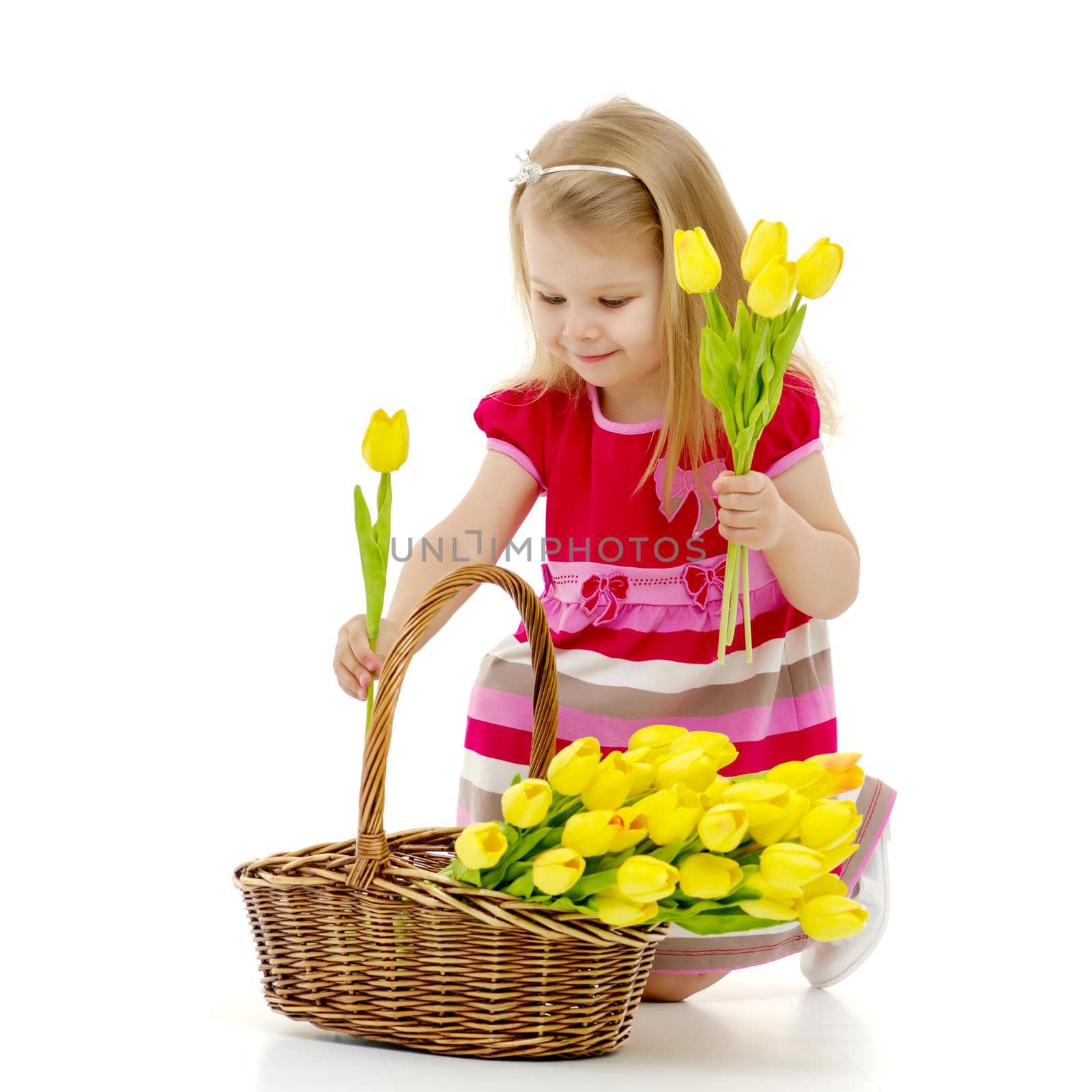 Cute little girl with a basket of flowers. by kolesnikov_studio