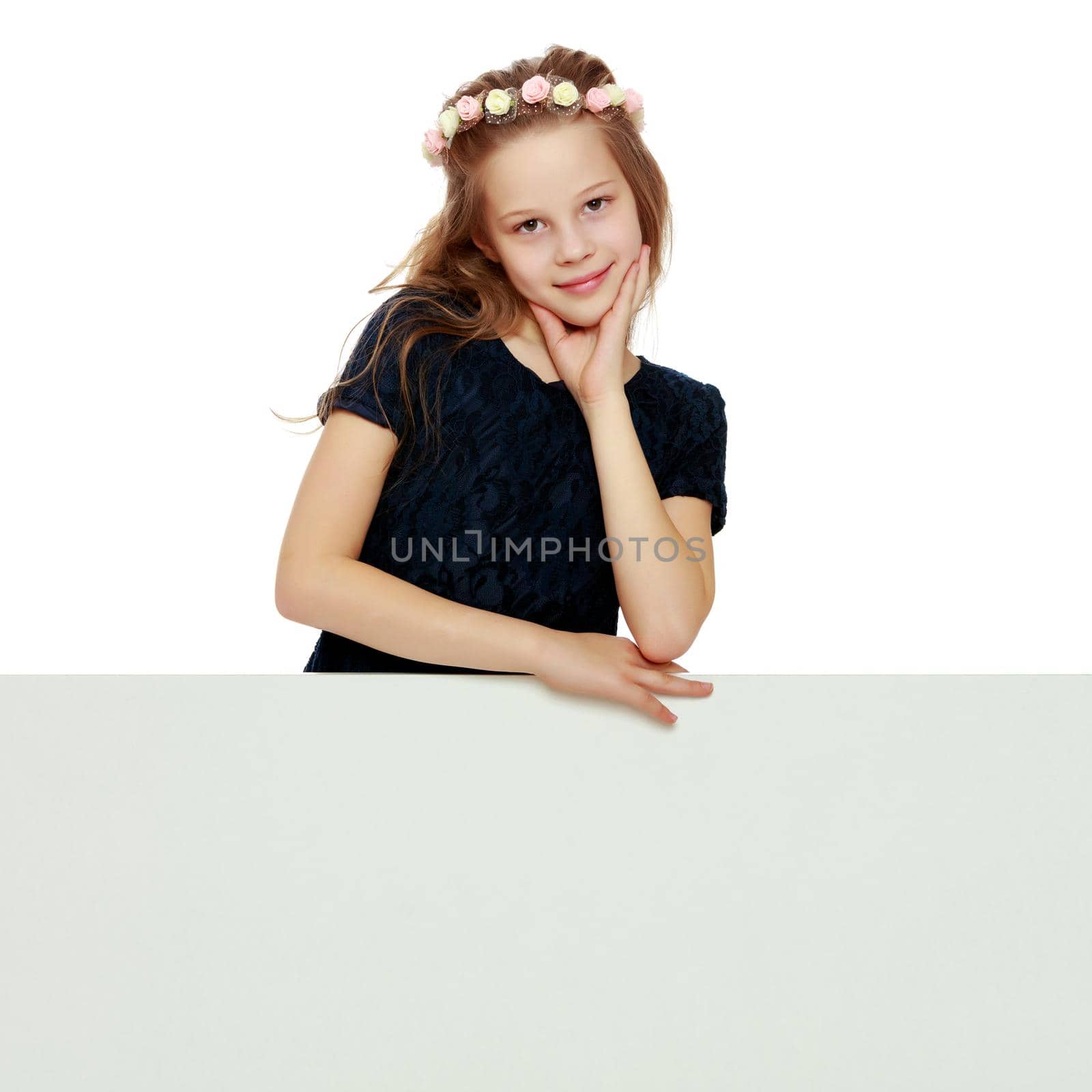 A little girl is looking from behind an empty banner. by kolesnikov_studio