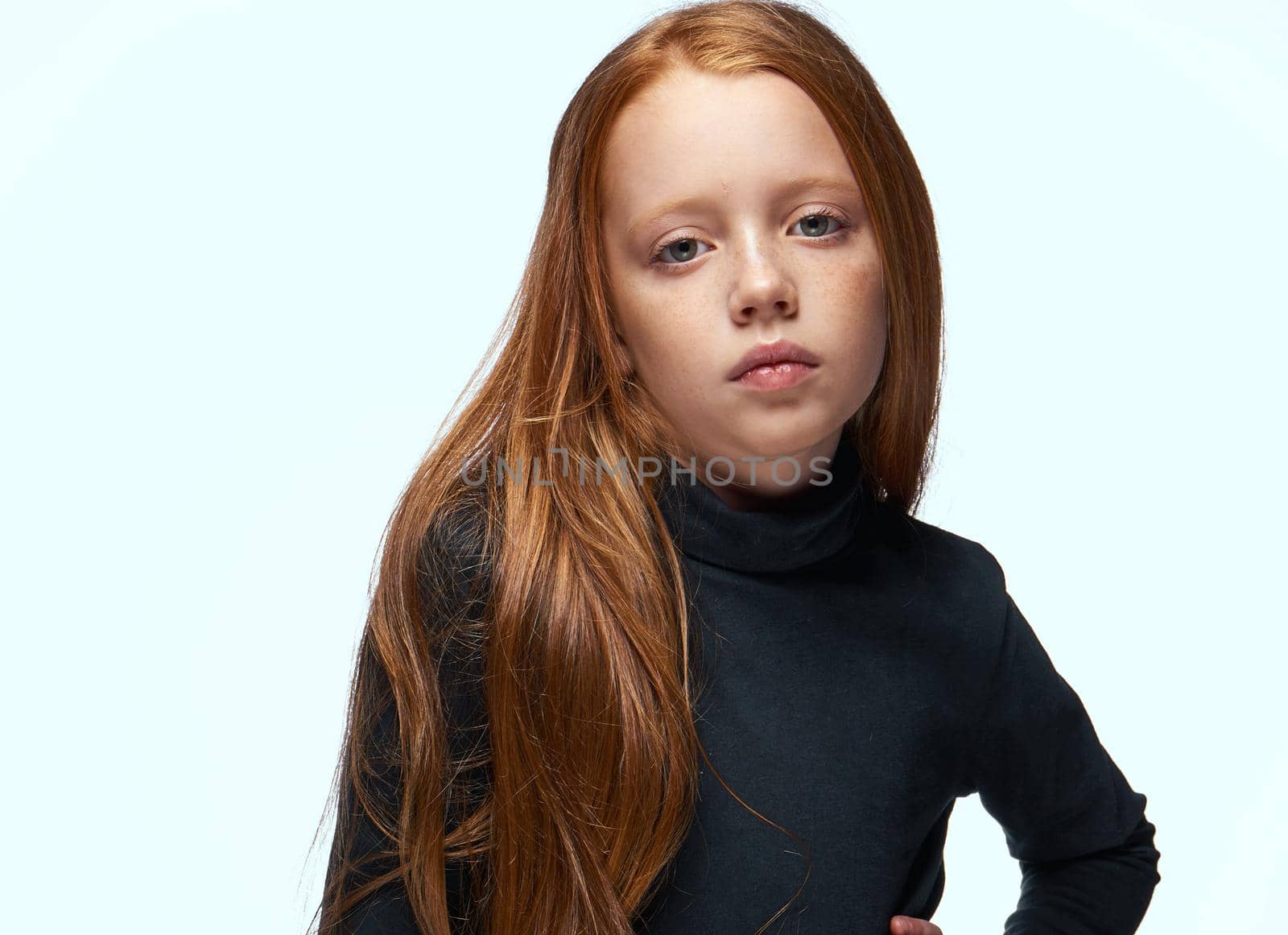 red-haired girl in a black sweater planning close-up. High quality photo