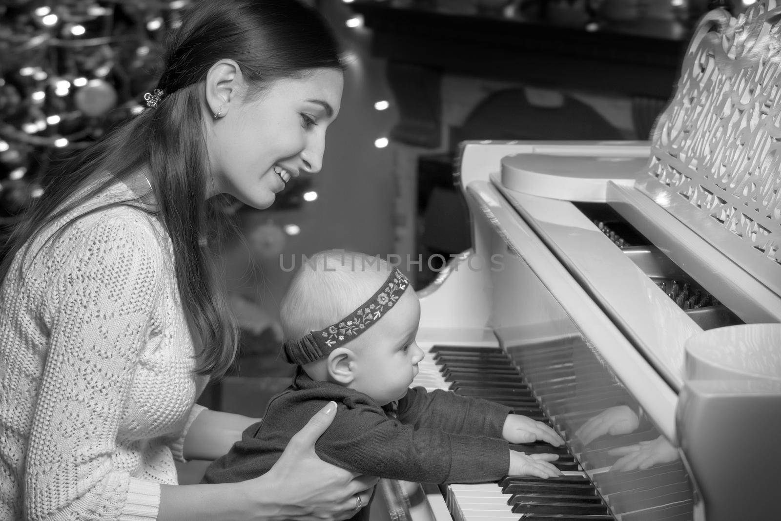 Mom with a child near a white piano by kolesnikov_studio