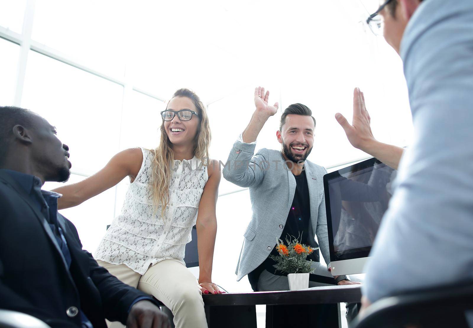 employees greet each other in the office by asdf