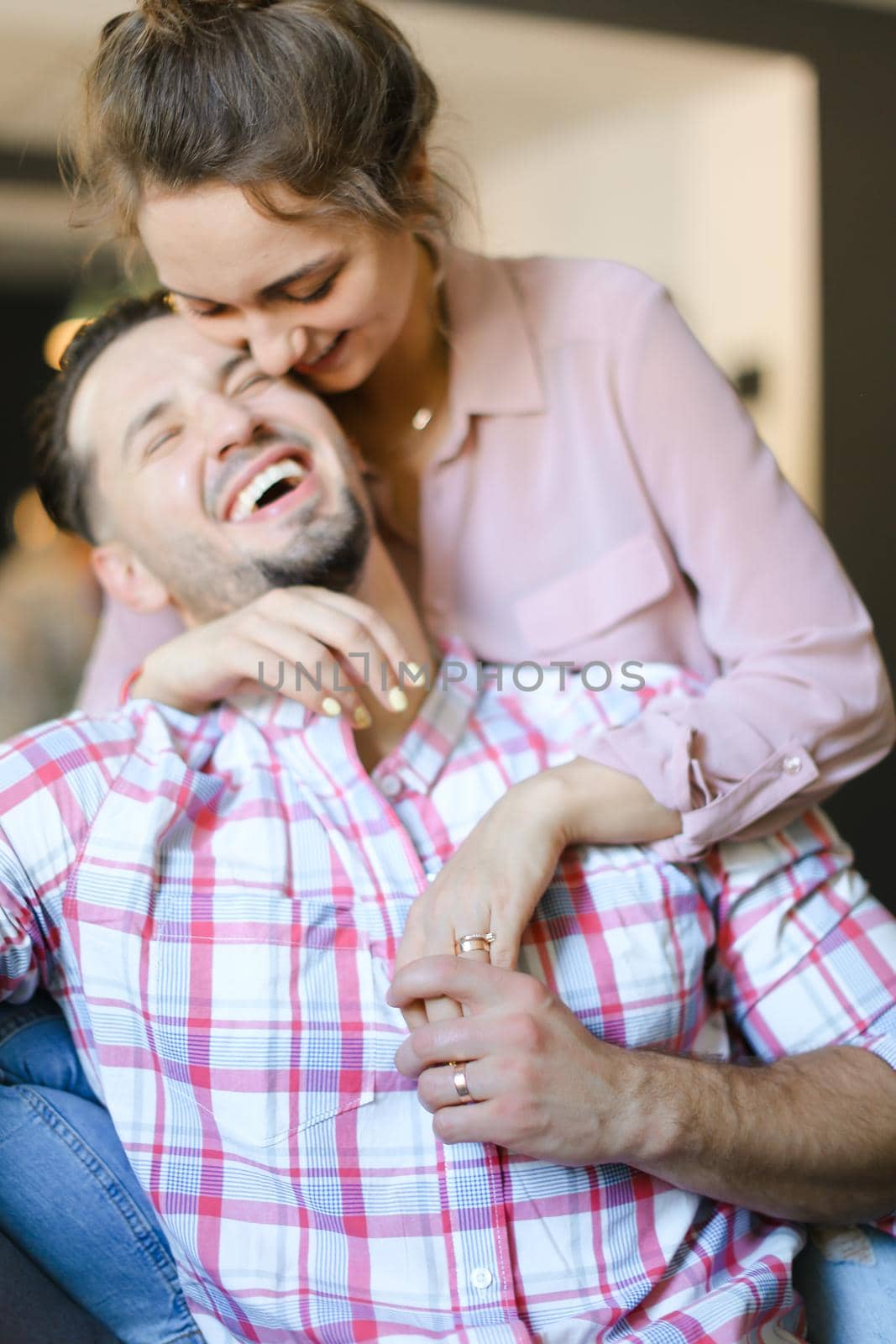 Nice female person kissing man wearing shirt. Concept of spending time together, love and feelings.