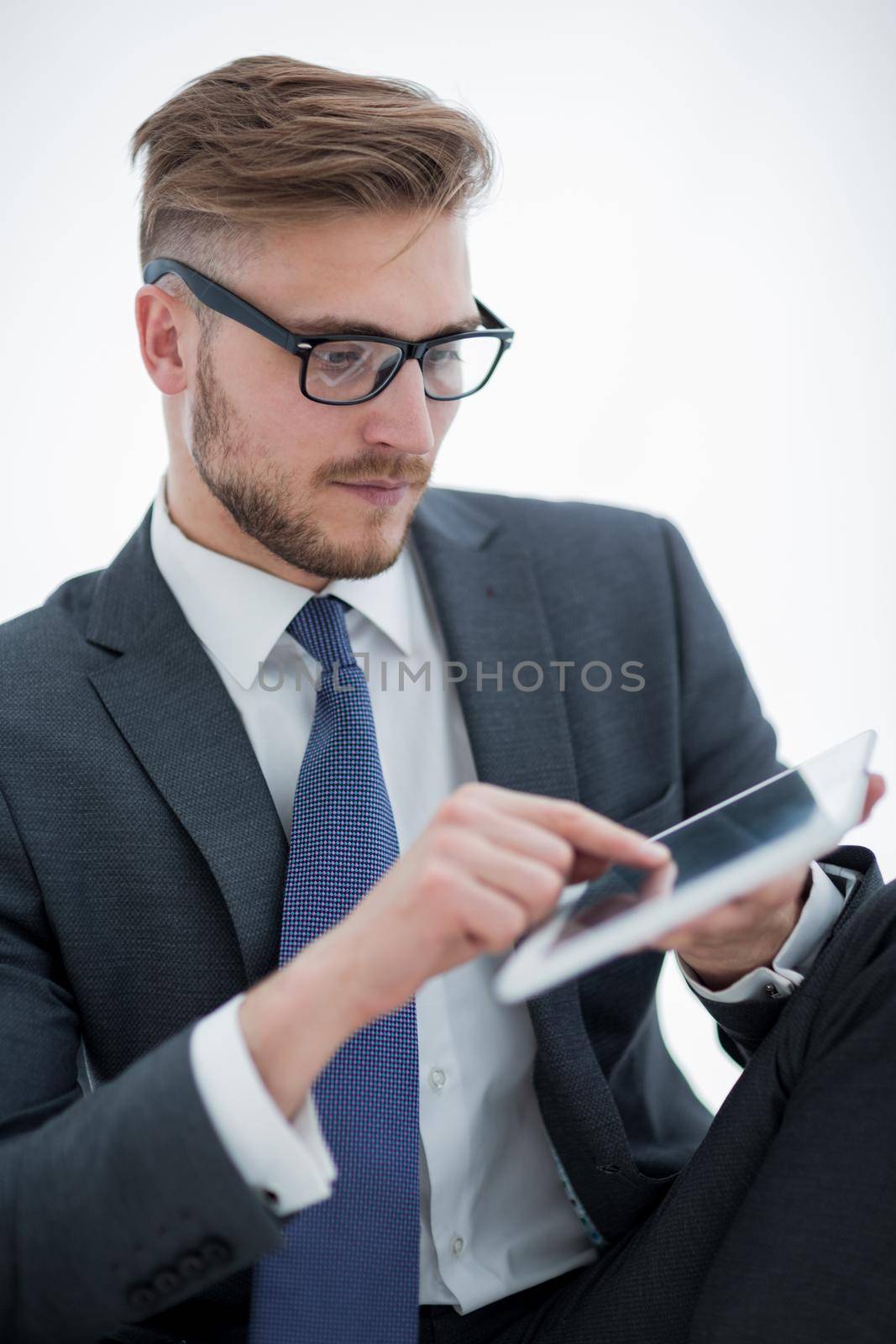 close up.attentive businessman clicking on the screen of the digital tablet.people and technology
