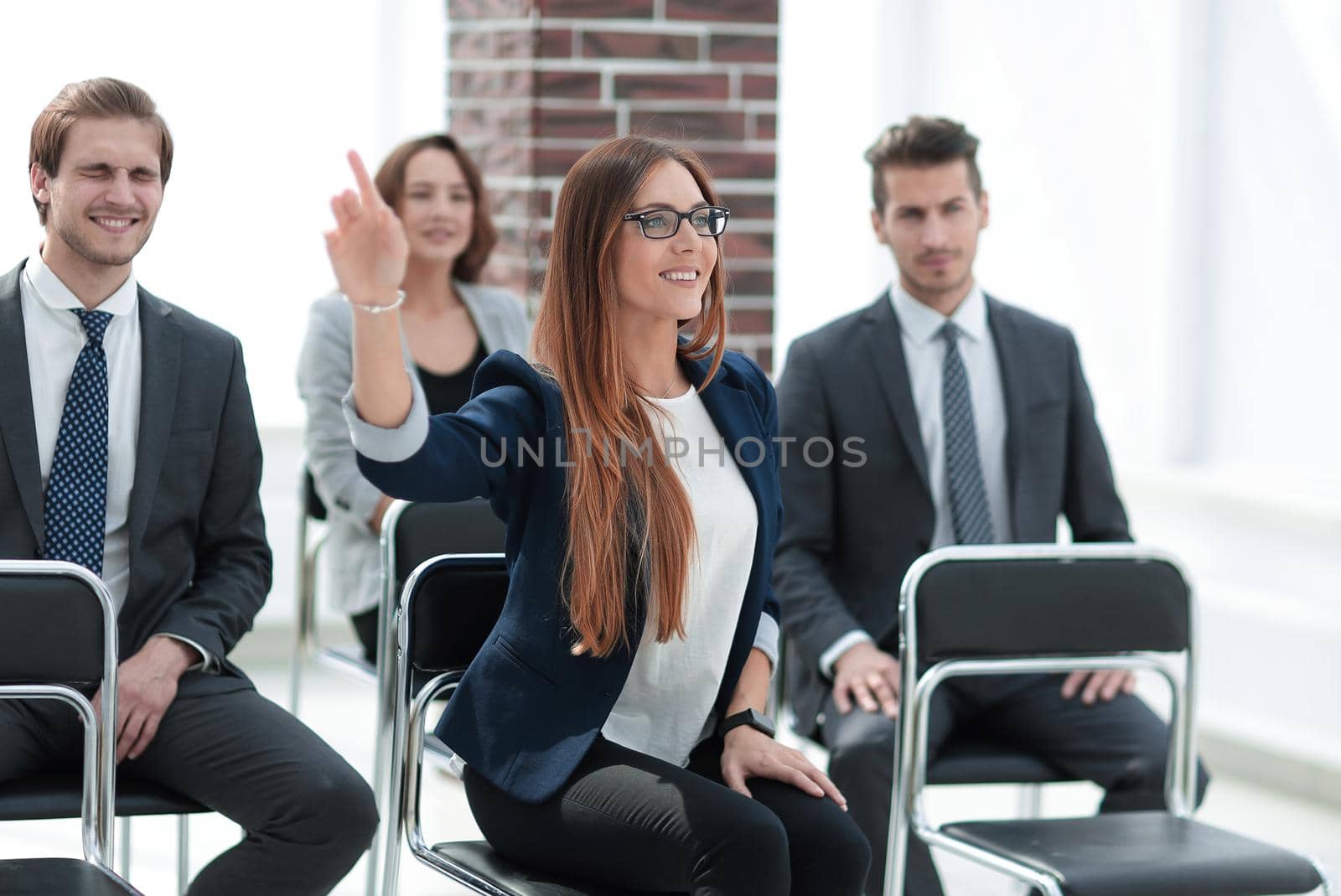Happy businesswoman sitting at office desk, smiling. Full length portrait. Isolated on white background.
