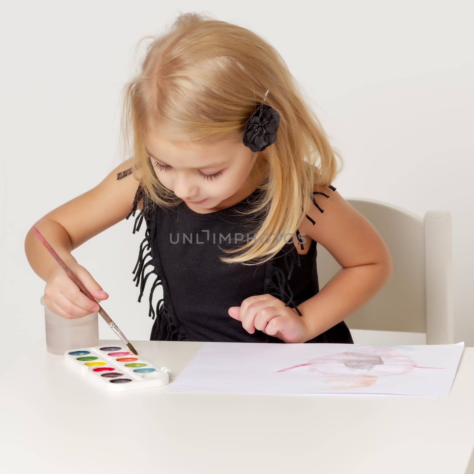 Little girl draws paints. by kolesnikov_studio