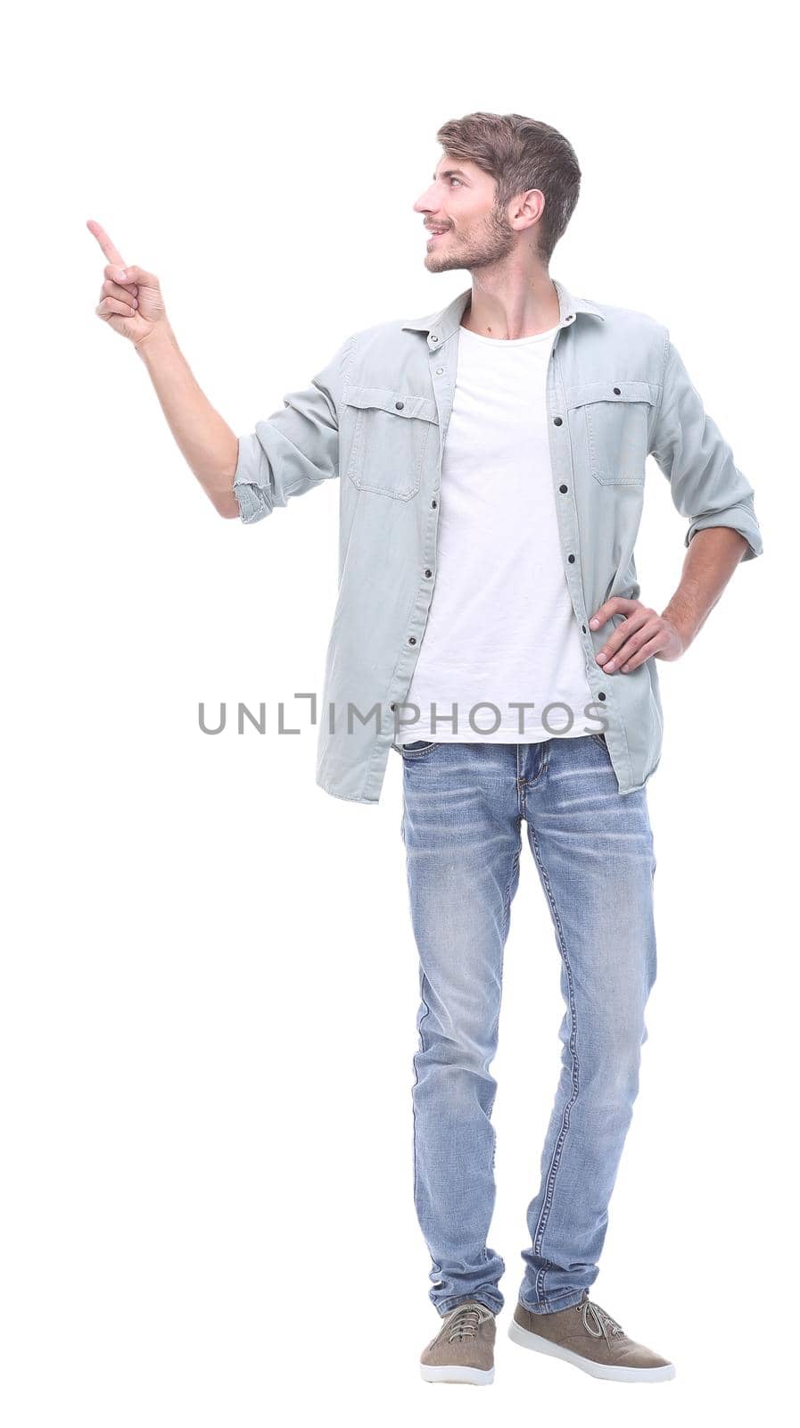 in full growth. successful young man showing on copy space.photo with text place